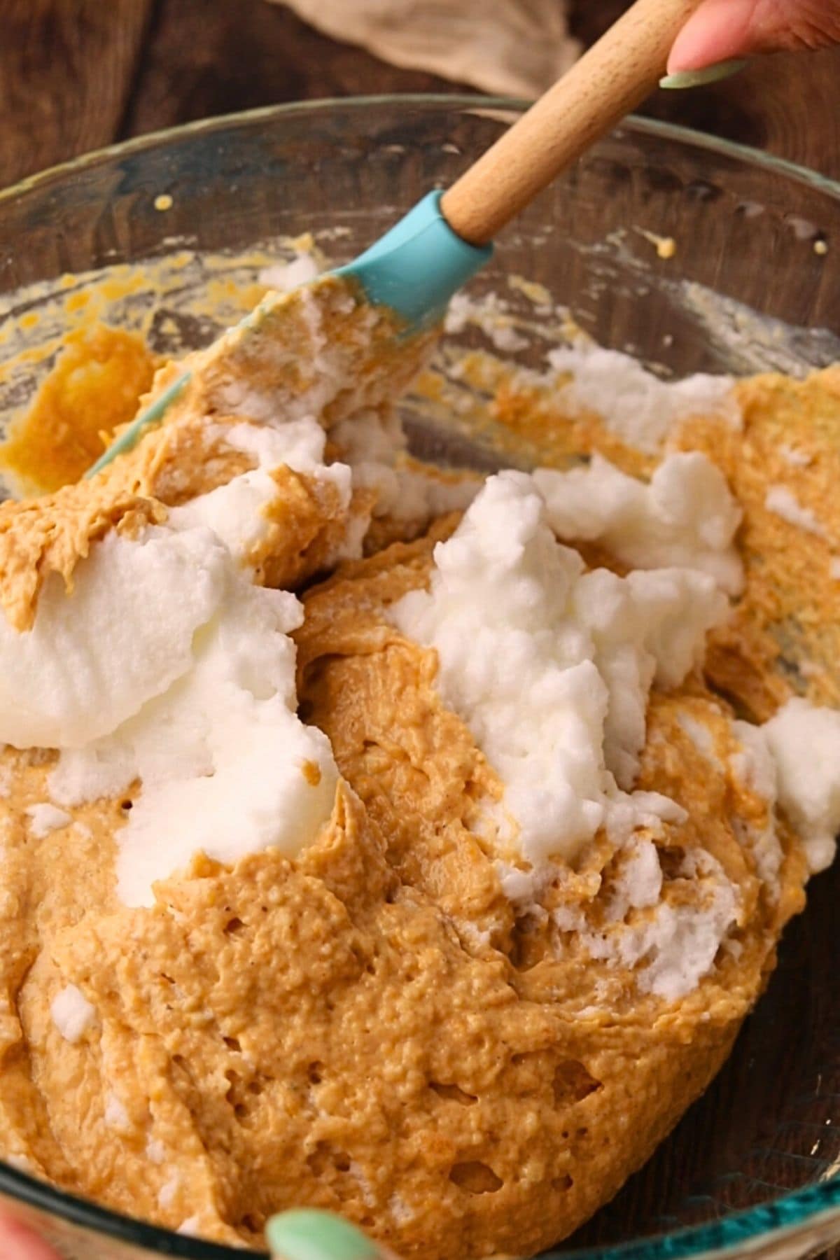 Egg whites being folded into sweet potato, waffle batter.