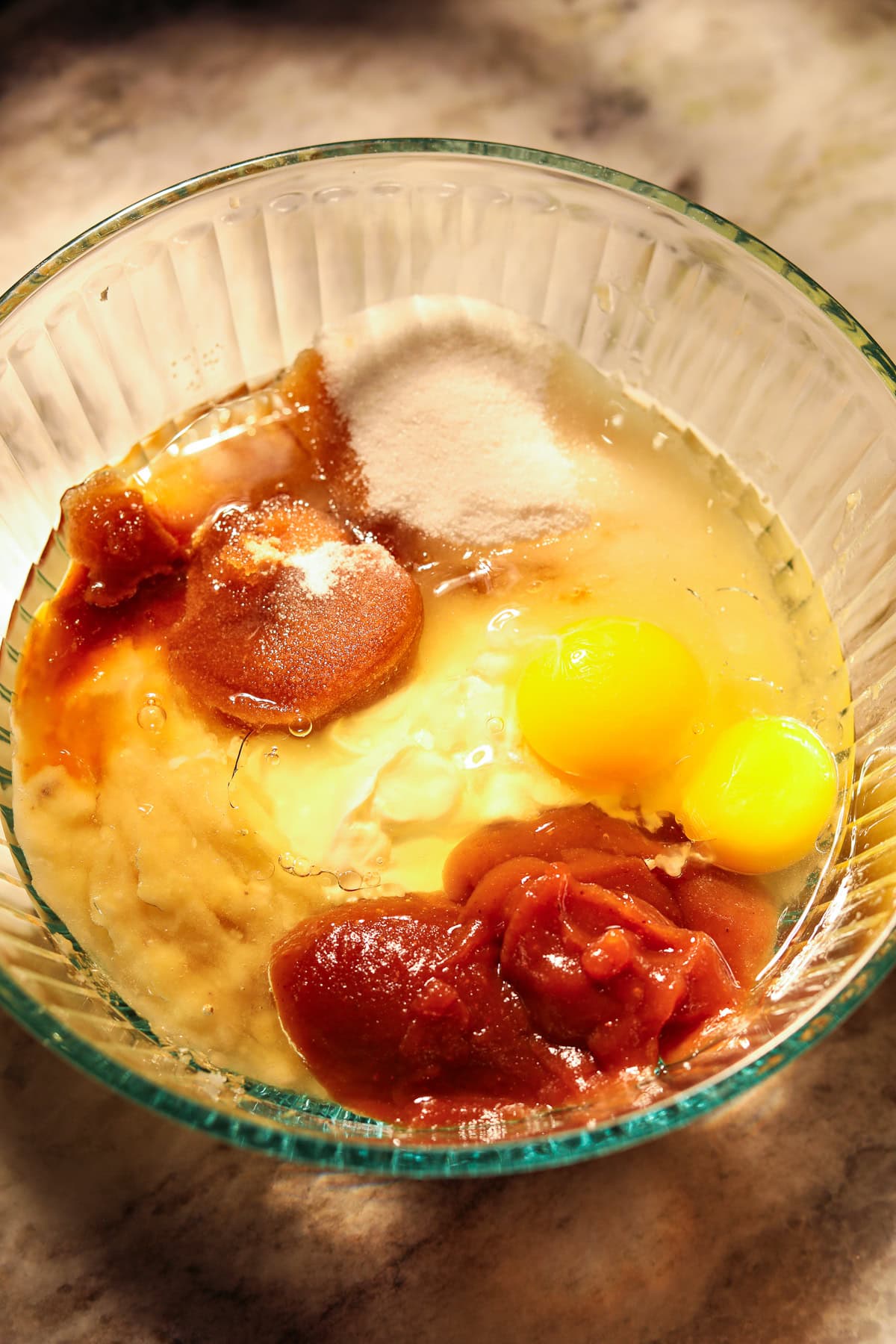 Apple butter, banana bread, wet ingredients in a mixing bowl.