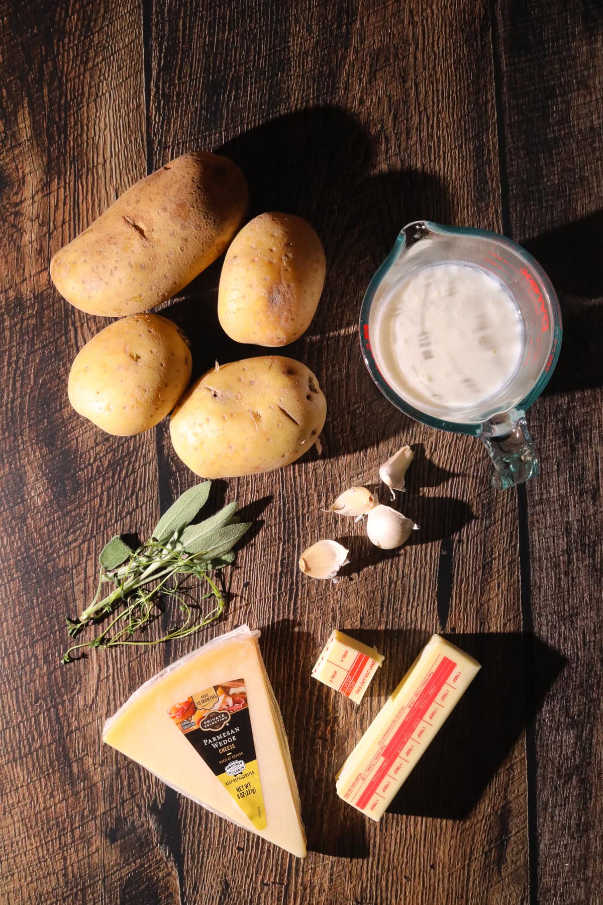 Ingredients for making brown butter, sage, mashed potatoes on a table top.