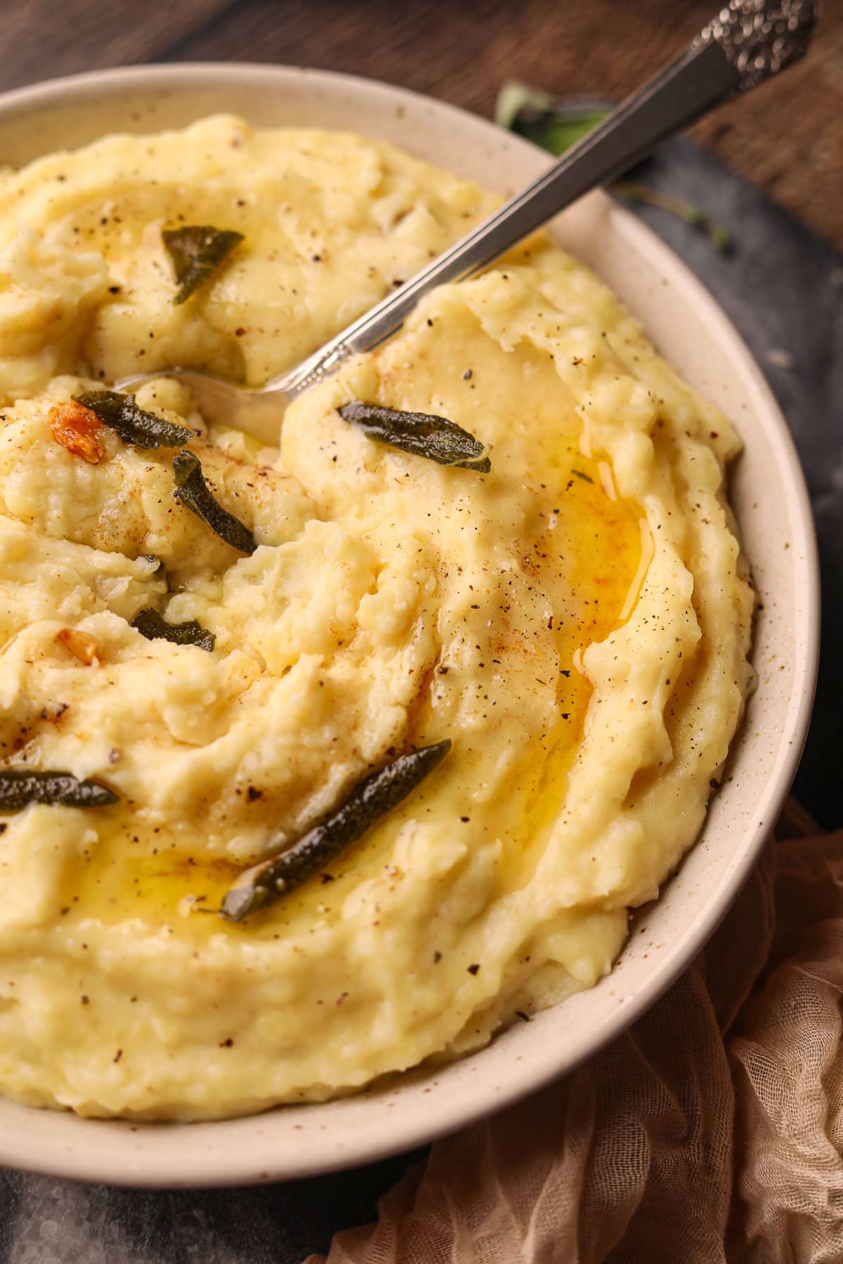 Brown butter, sage, mashed potatoes in a serving bowl.