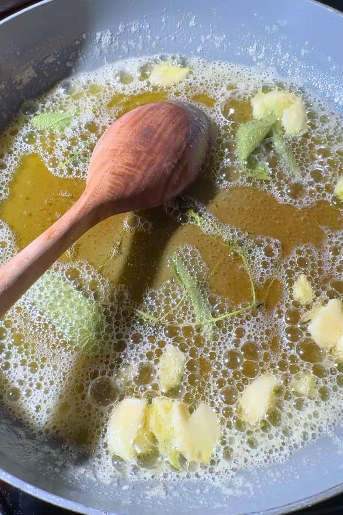 Brown butter in a skillet with garlic and herbs.