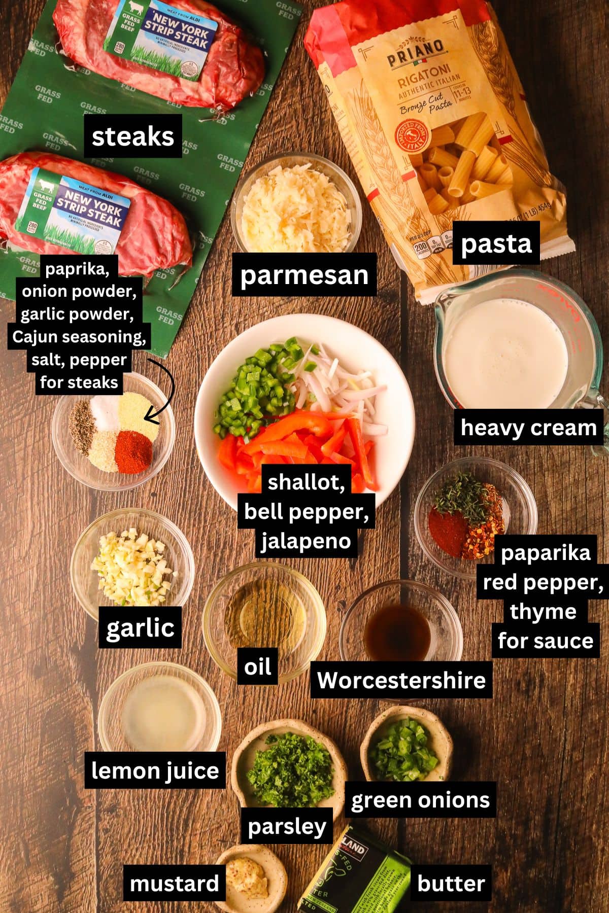 Ingredients for making cowboy butter, steak, rigatoni arranged on a table top.