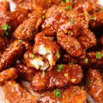 Crispy hot honey, garlic chicken bites on a plate.