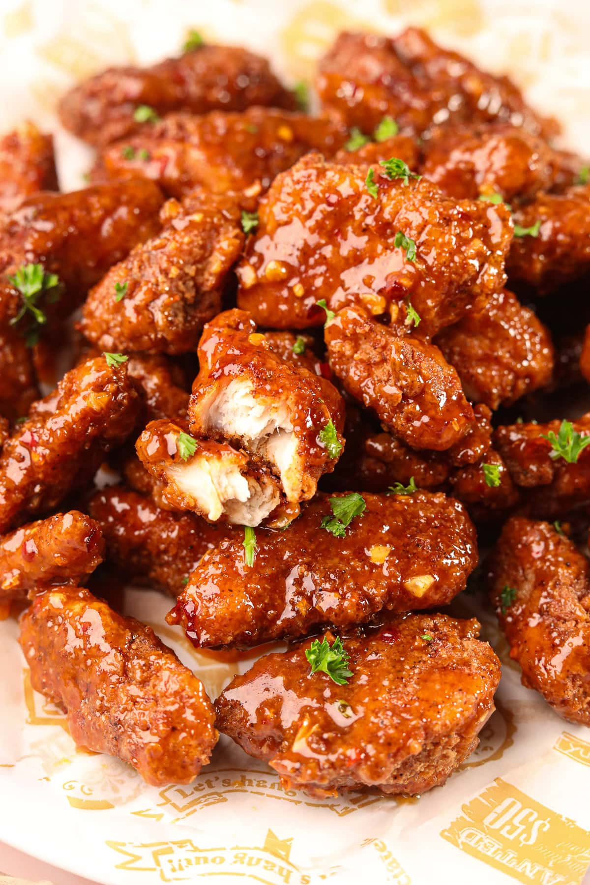 Crispy hot honey, garlic chicken bites on a plate.