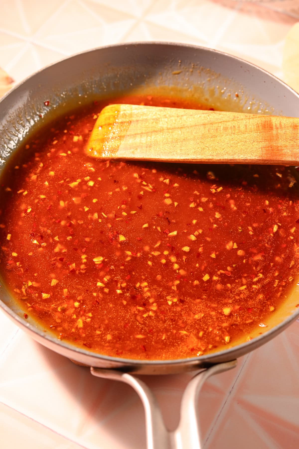 Hot honey garlic sauce in a saucepan.