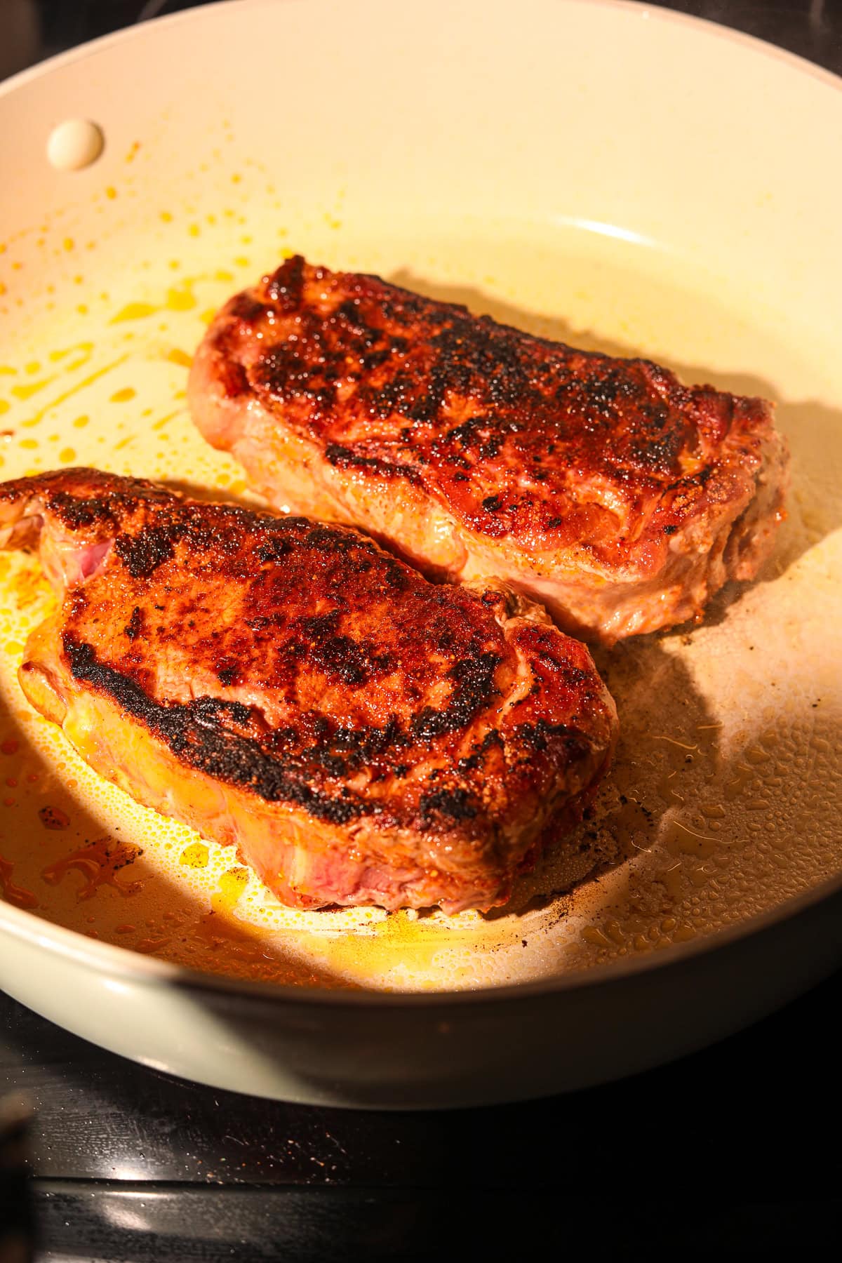 Steaks, searing in a skillet for cowboy butter rigatoni.