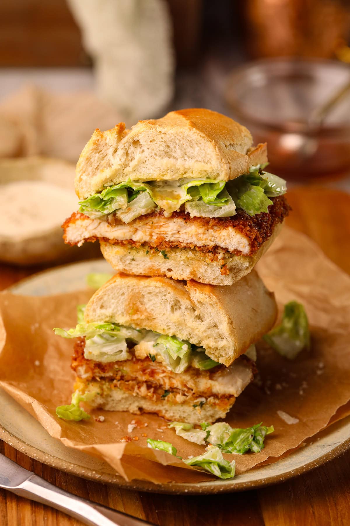 Spicy chicken, Caesar sandwich assembled on a plate.