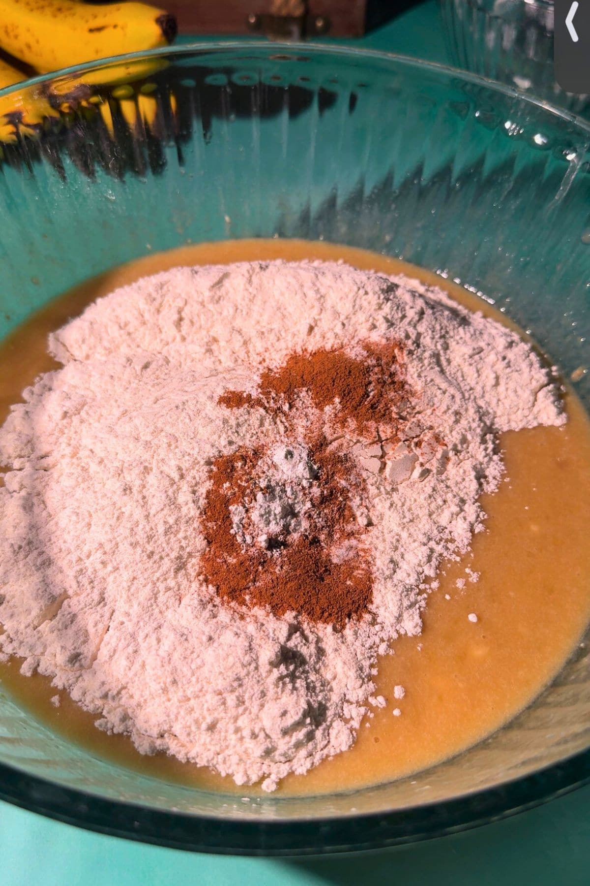 Cinnamon swirl banana muffins batter ingredients in a mixing bowl.