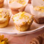 Lemon cream cheese muffins on a serving platter.