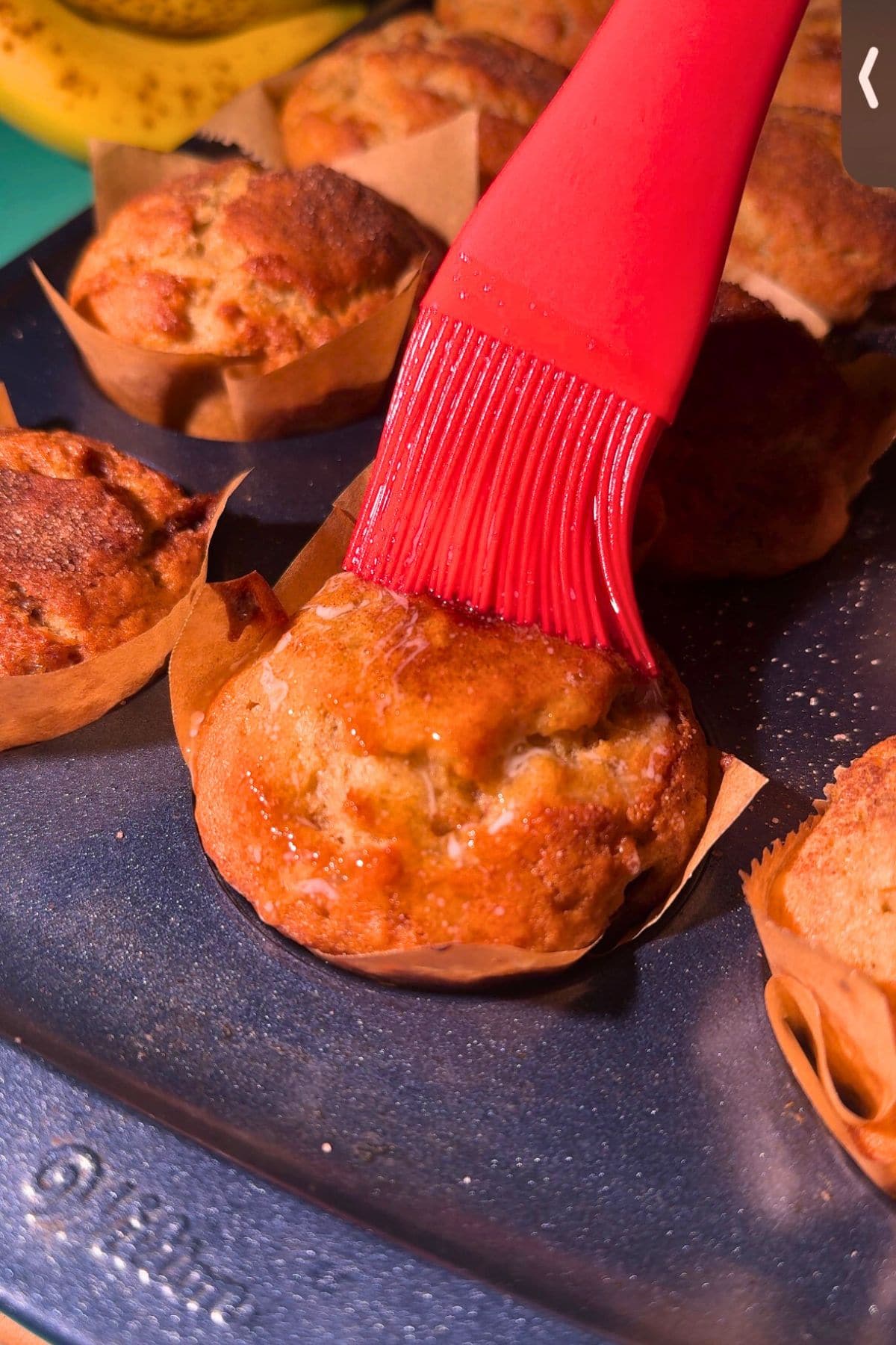 Cinnamon swirl banana muffins, brushed with melted butter.