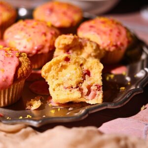 Strawberry lemonade, muffins on a platter with one sliced in half to show detail.