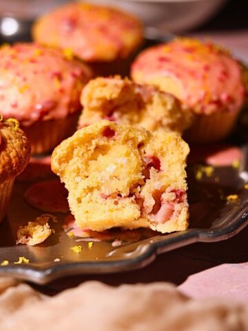 Strawberry lemonade, muffins on a platter with one sliced in half to show detail.