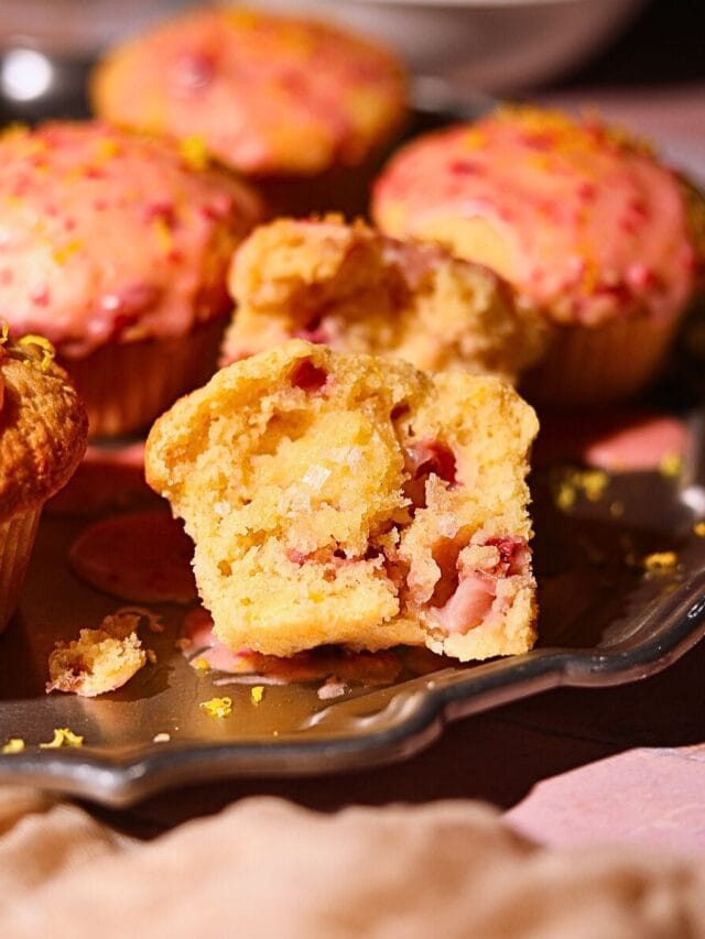 Strawberry lemonade, muffins on a platter with one sliced in half to show detail.