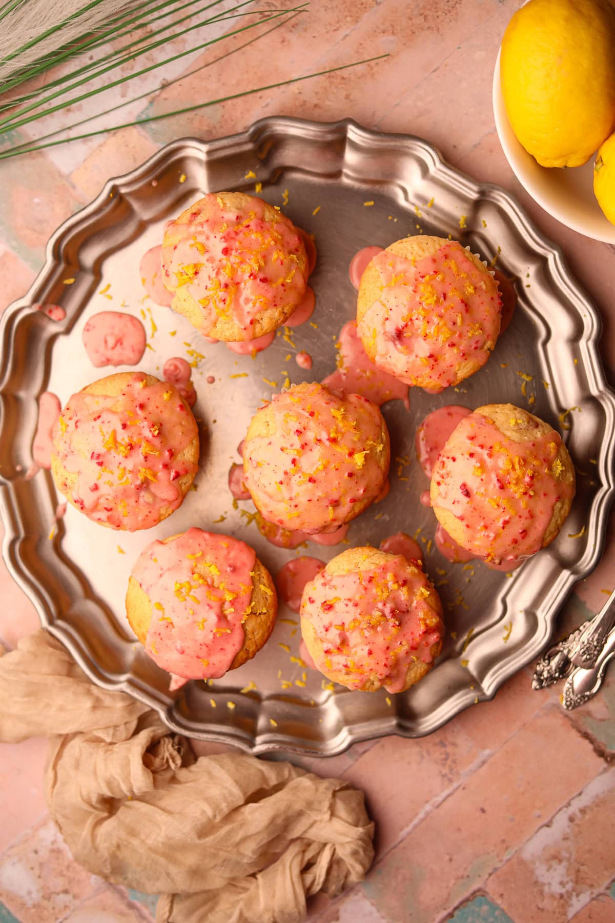 Overhead shot of strawberry lemonade, muffins on a serving platter. 