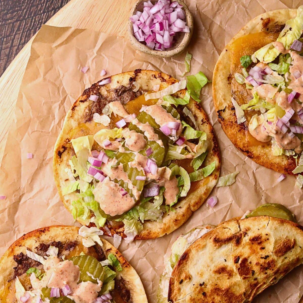 Smashburger tacos on a wooden cutting board.