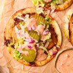 Smashburger tacos on a wooden cutting board.