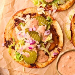 Smashburger tacos on a wooden cutting board.