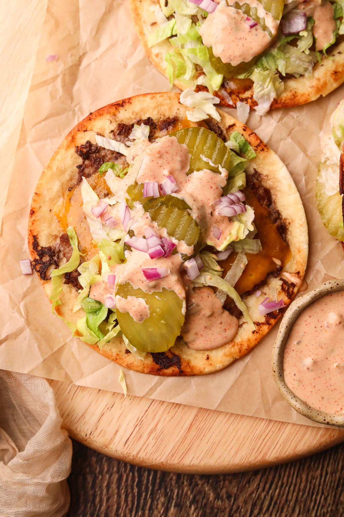 Smashburger tacos on a wooden cutting board.