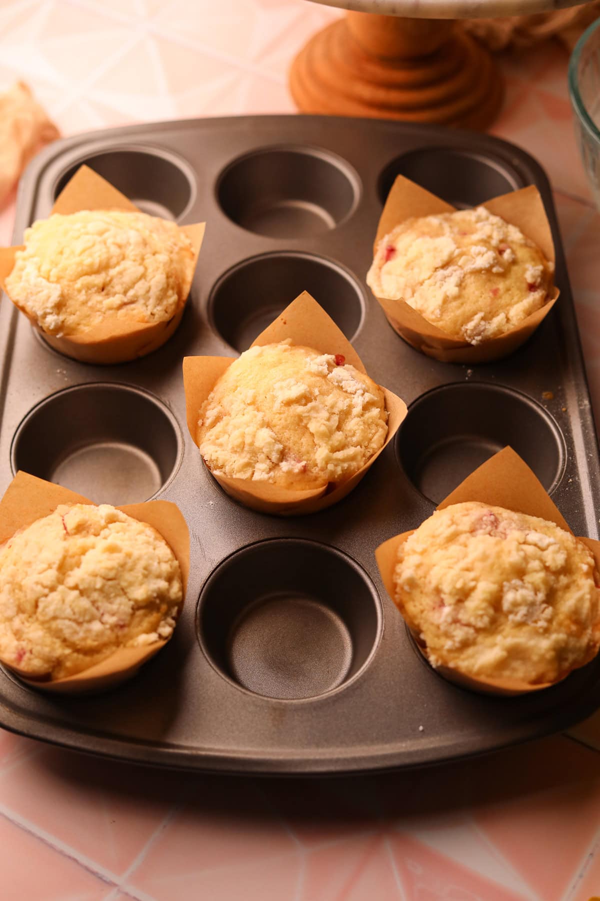 Freshly baked strawberry shortcake muffins with crumble topping.