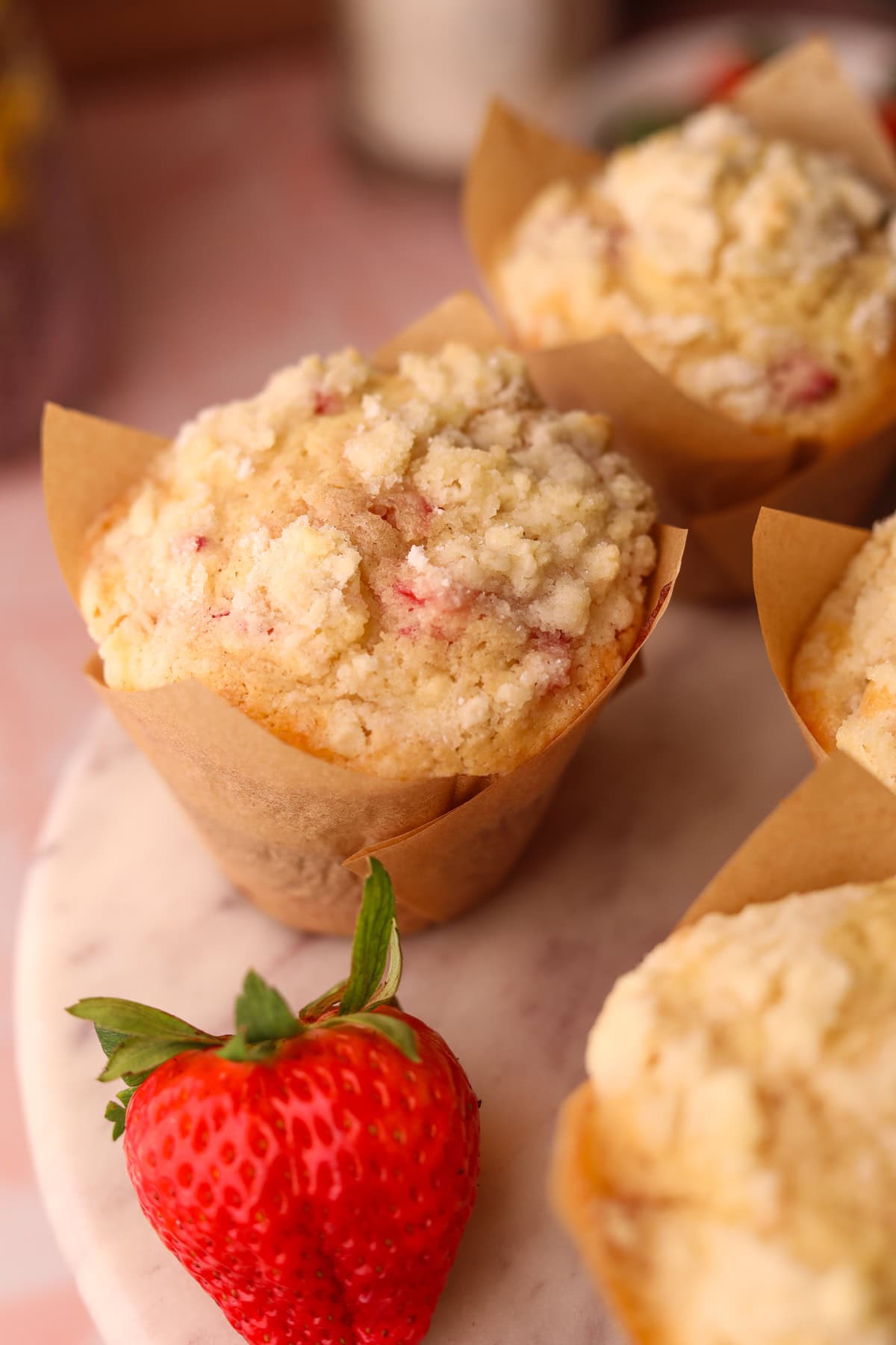 Strawberry short cake muffins on a cake platter.