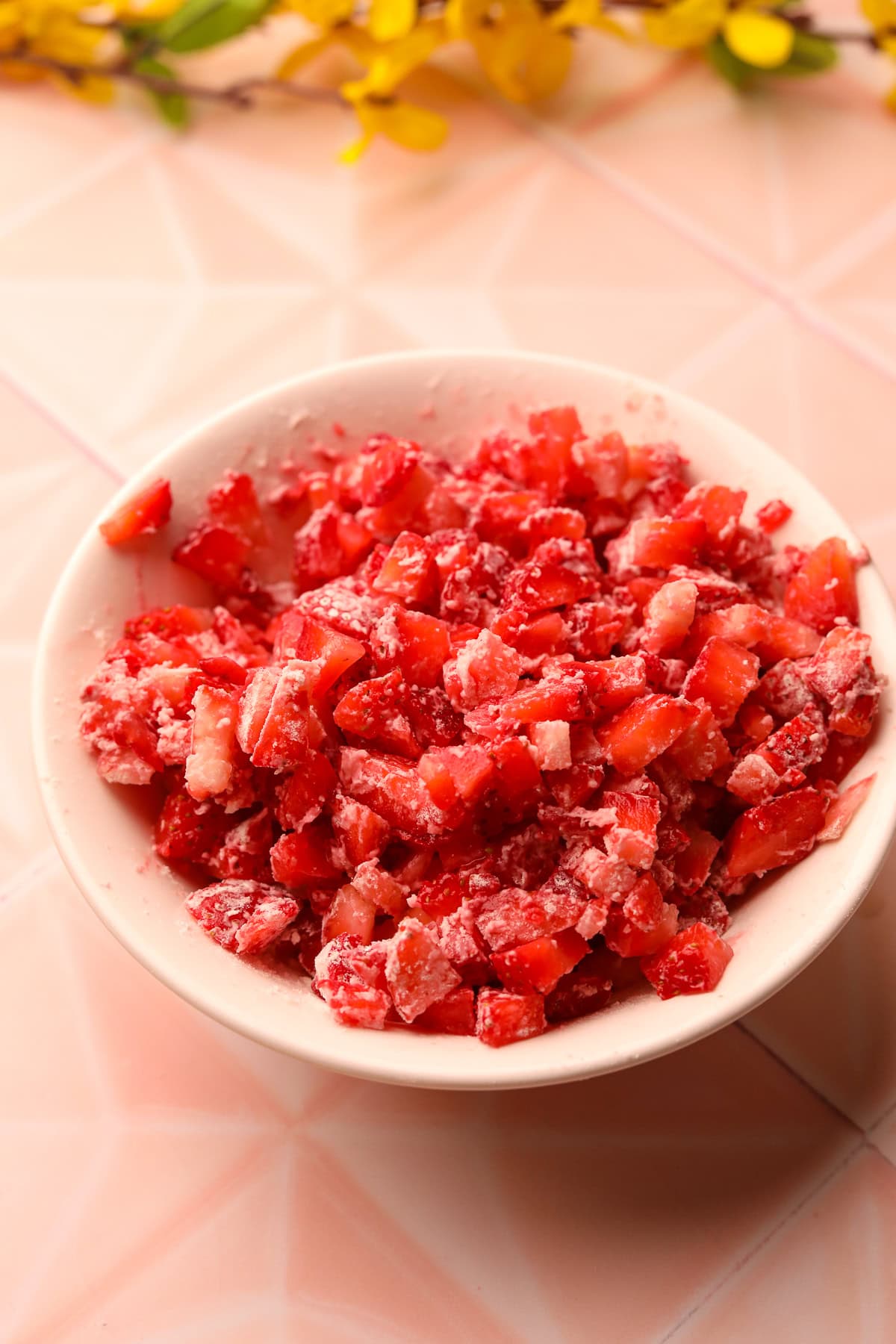 Diced strawberries in a ball tossed with flour.