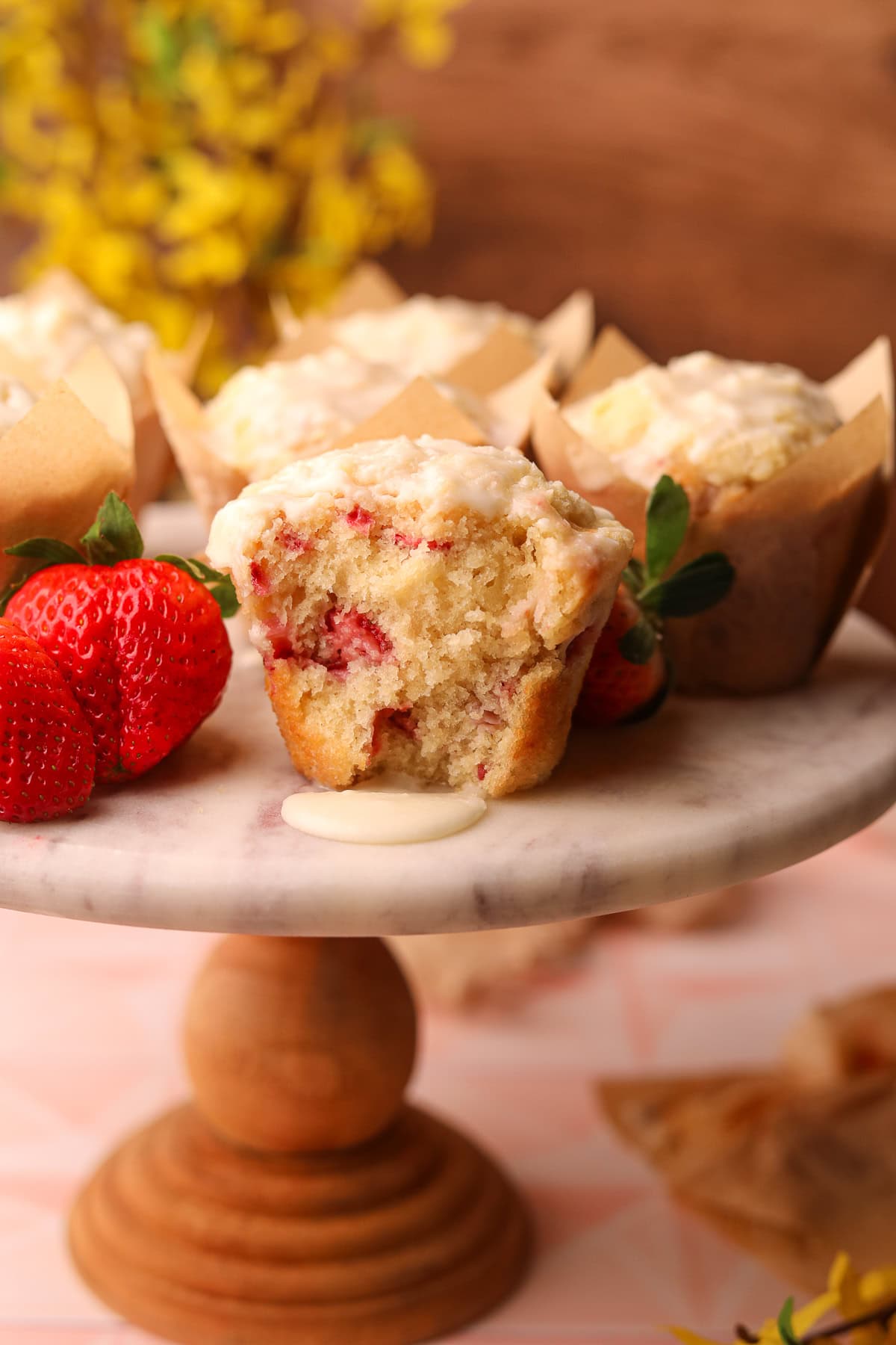 Strawberry short cake muffins on a cake platter. 