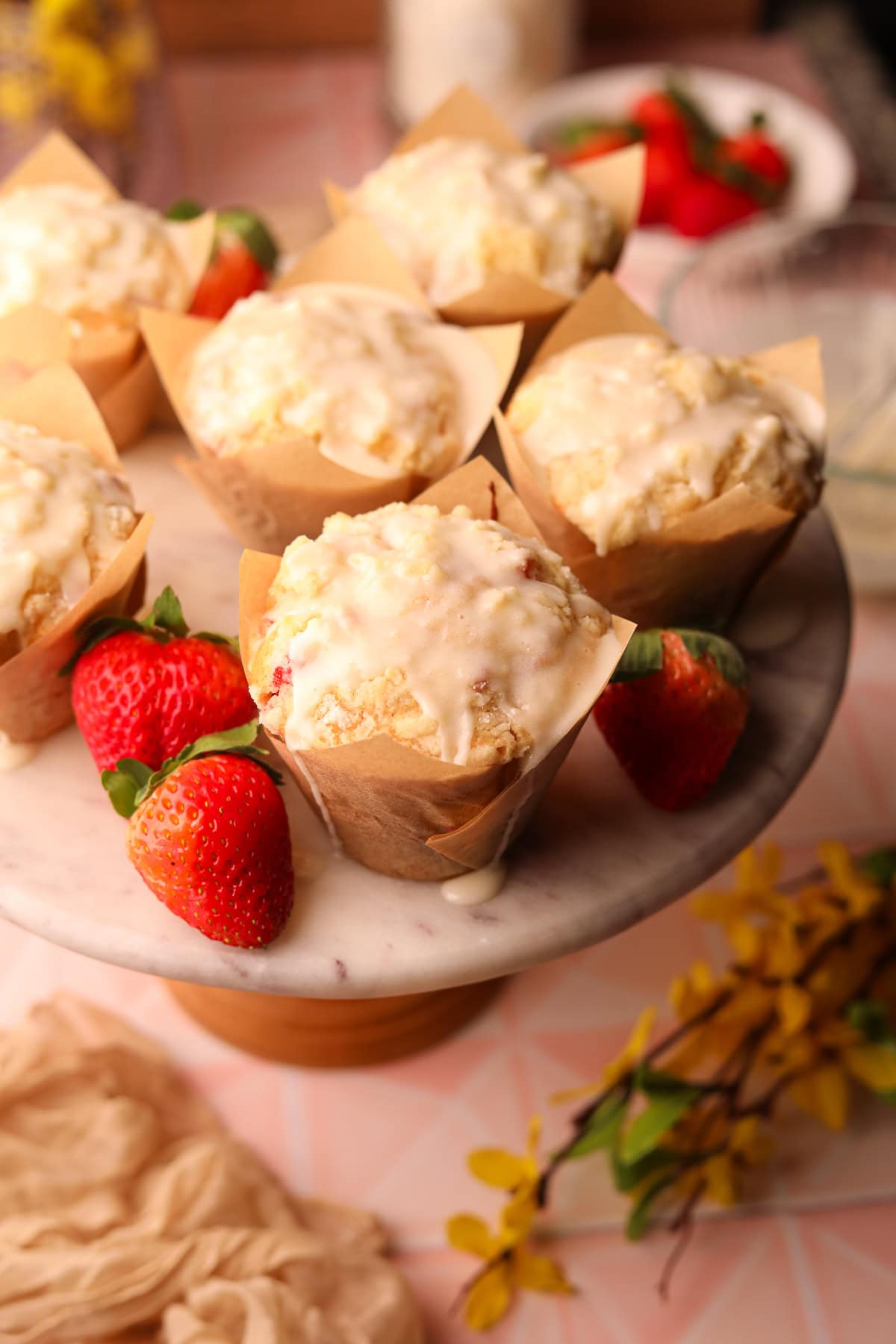 Strawberry short cake muffins on a cake platter.