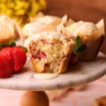 Strawberry short cake muffins on a cake platter.