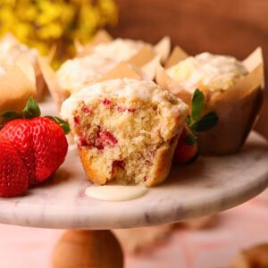 Strawberry short cake muffins on a cake platter.