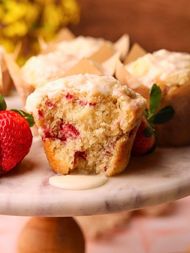 Strawberry short cake muffins on a cake platter.