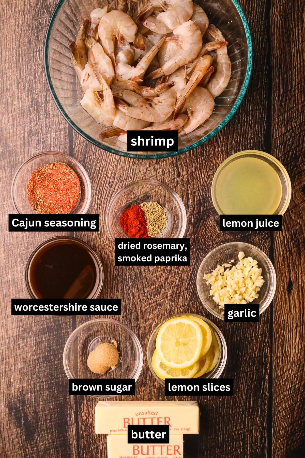 Ingredients for making New Orleans BBQ shrimp arranged on a table top.