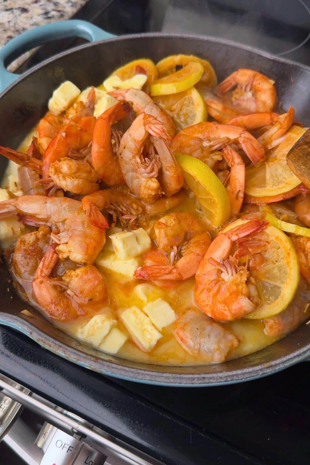 Butter and lemons add to New Orleans, BBQ, shrimp simmering on the stove top.