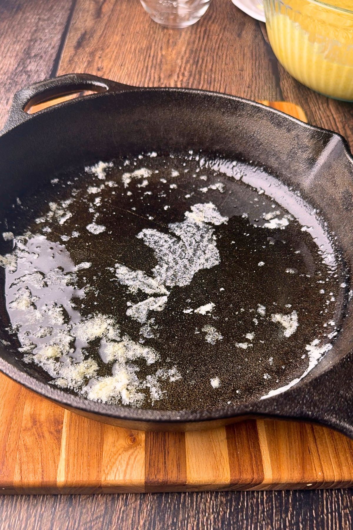 Melted butter in a cast-iron skillet for cast-iron skillet cornbread.