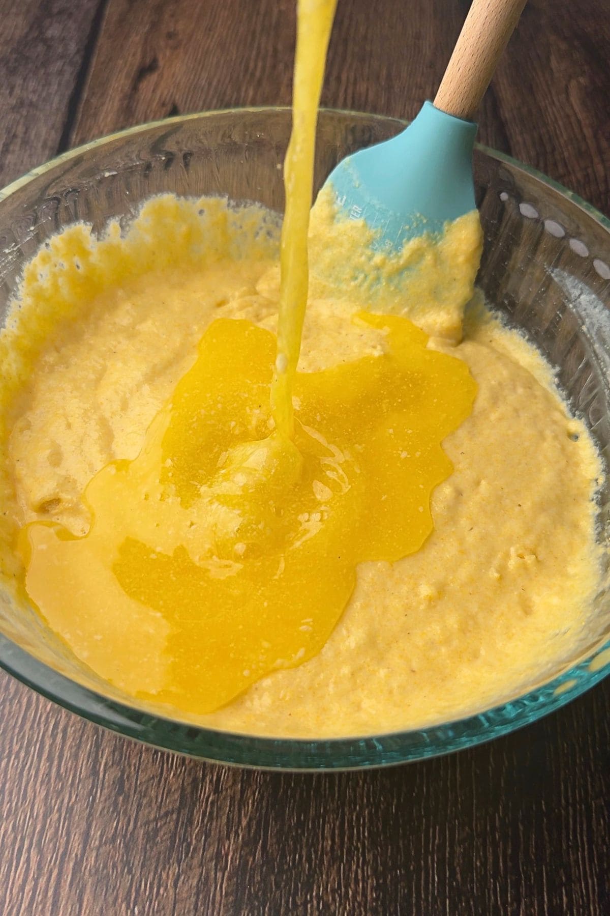 Southern cast-iron cornbread batter and a mixing bowl with melted butter being added.