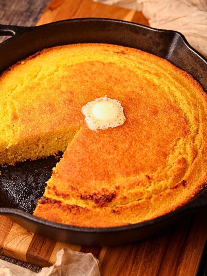 Southern cast-iron cornbread sliced in a skillet.