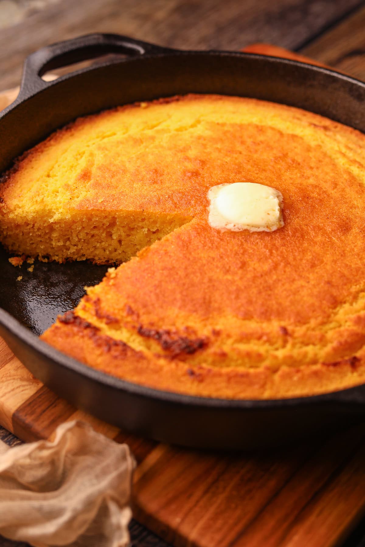 Southern cast-iron cornbread sliced in a skillet.
