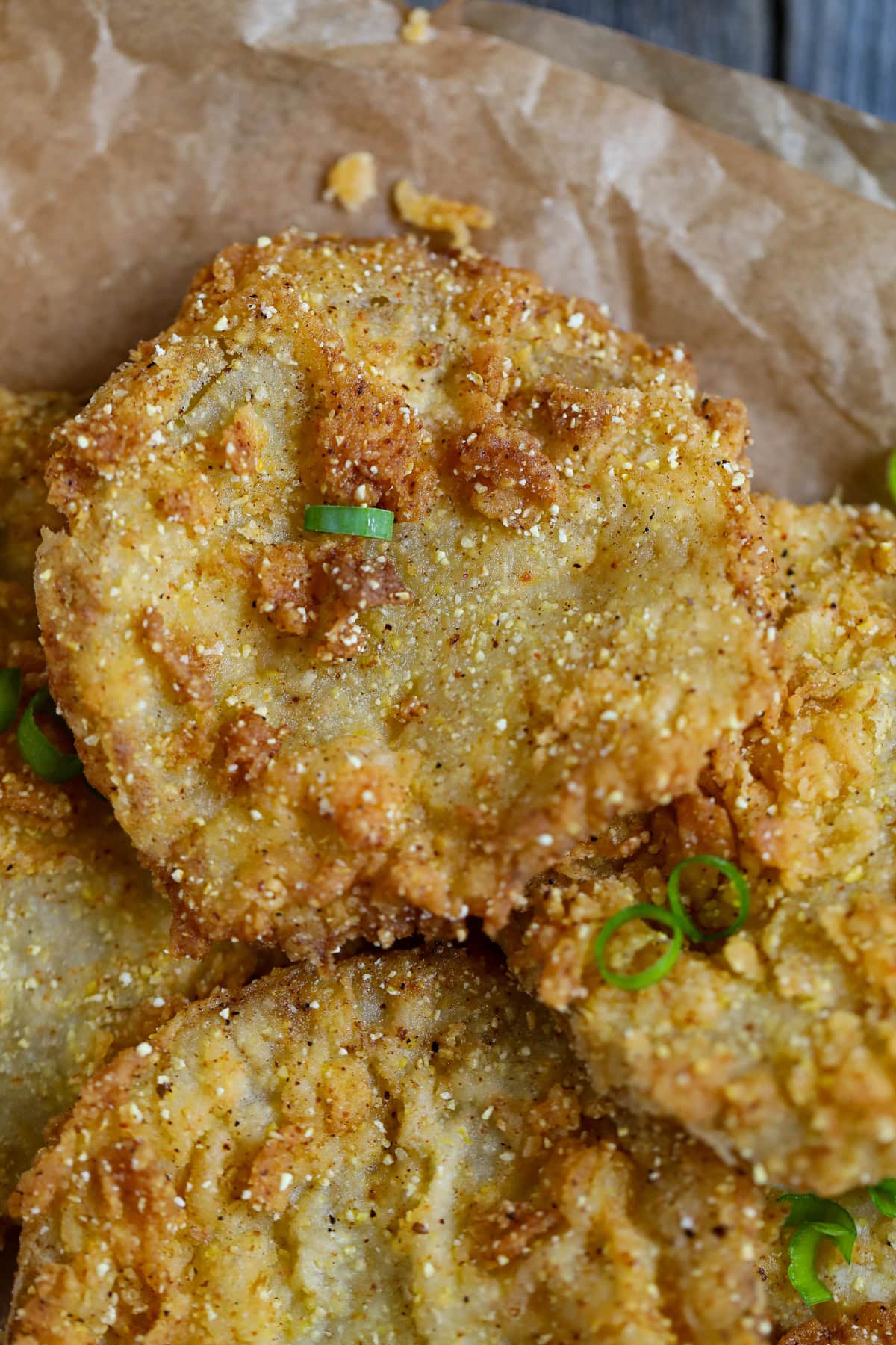 Fried green tomatoes on parchment paper.