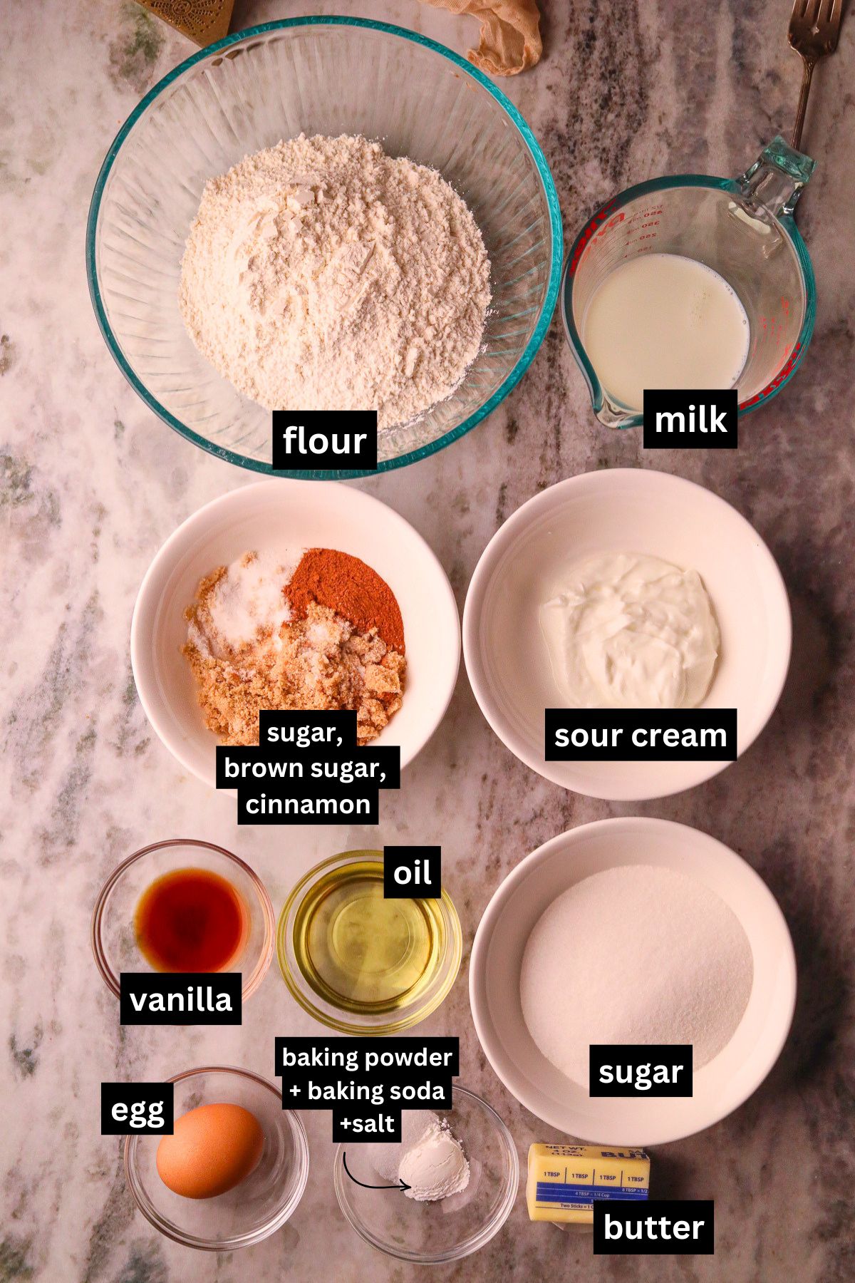 Ingredients for making cinnamon roll quick bread, arranged on a table top.