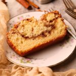 A slice of cinnamon roll quick bread on a dessert plate.