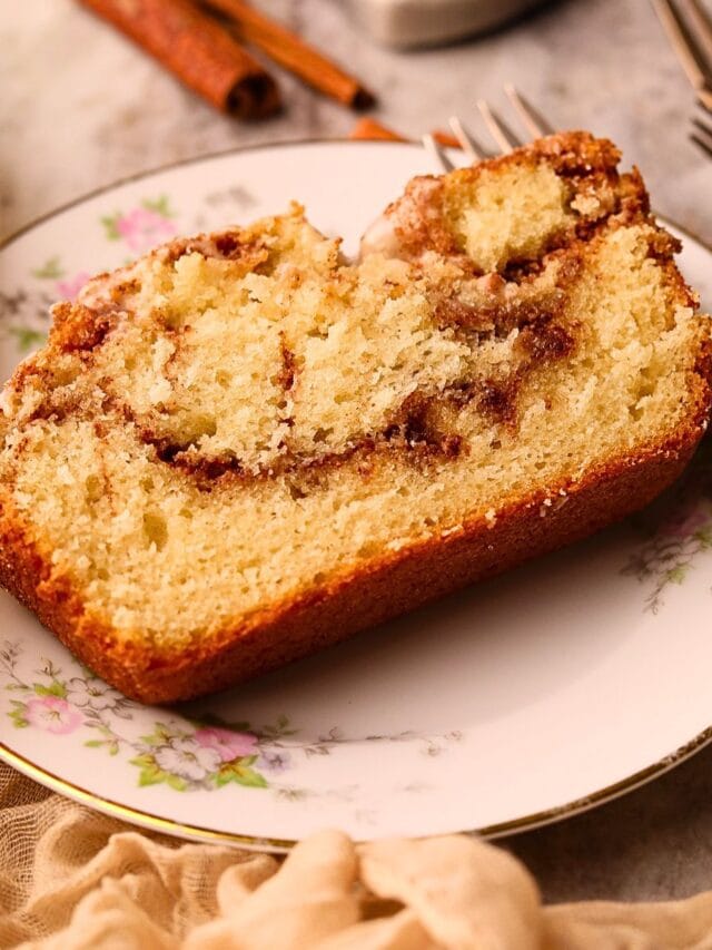 A slice of cinnamon roll quick bread on a dessert plate.