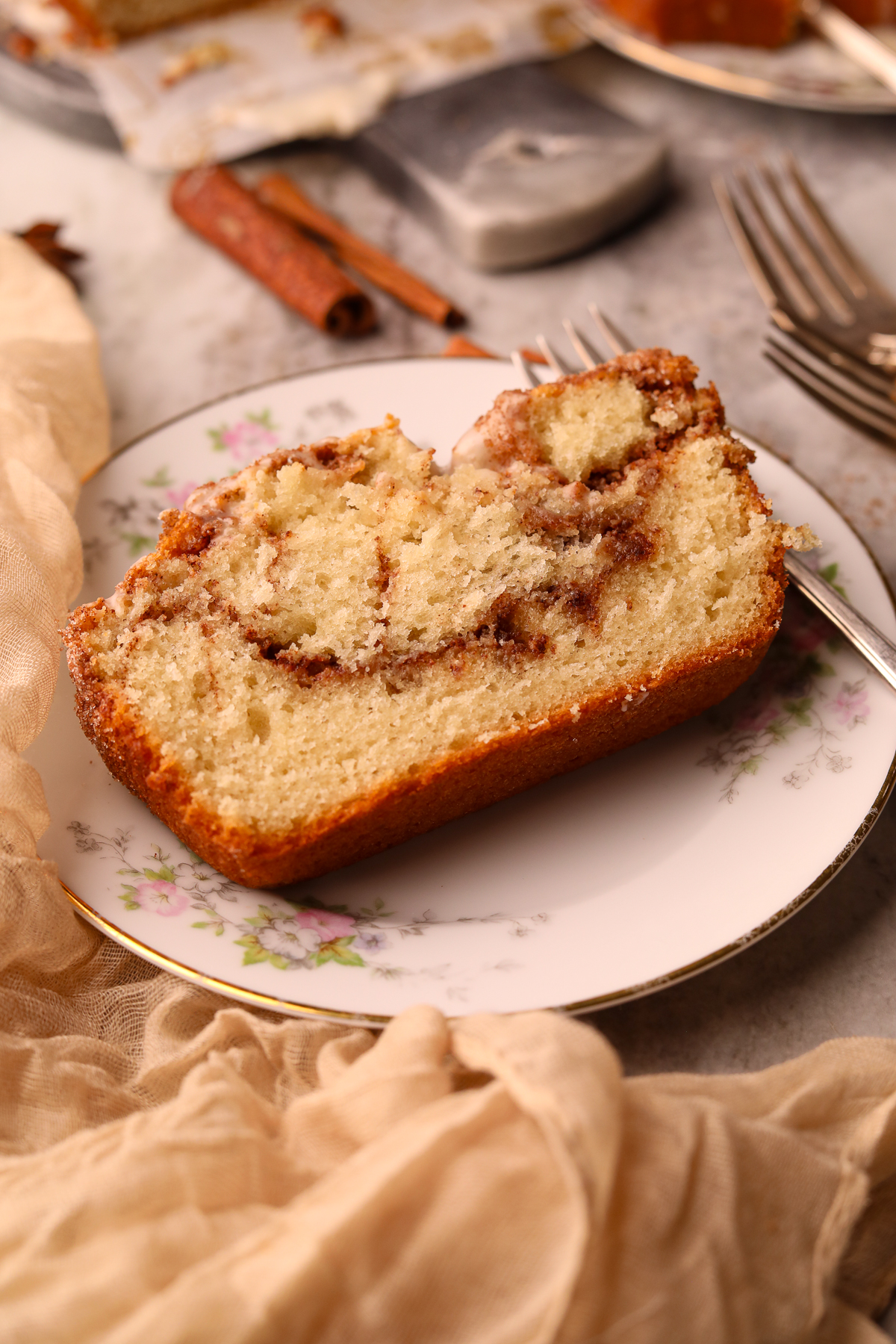 A slice of cinnamon roll quick bread on a dessert plate.