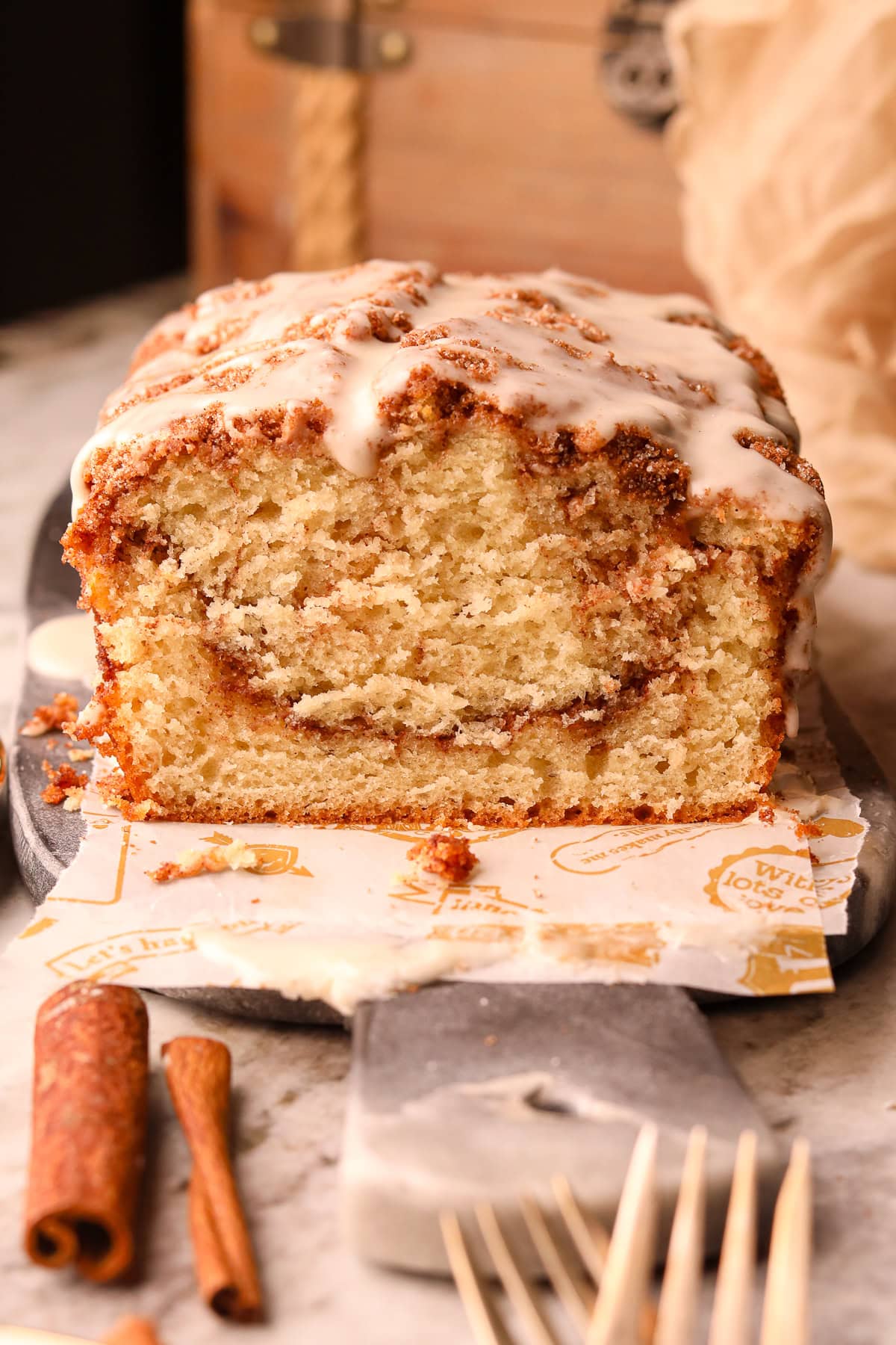 Cinnamon Roll quick bread loaf, sliced on a serving board.