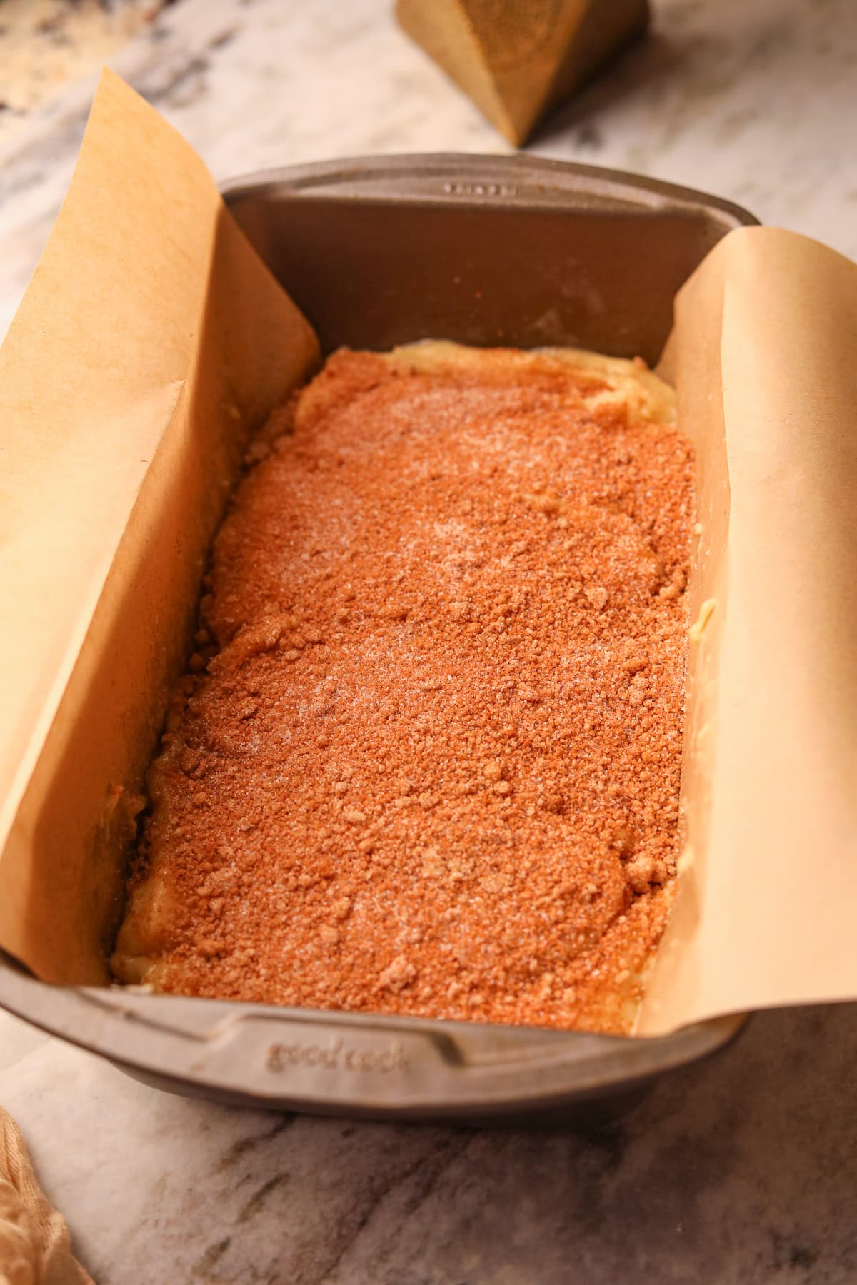 Swirl cinnamon roll quick bread batter in a loaf pan.